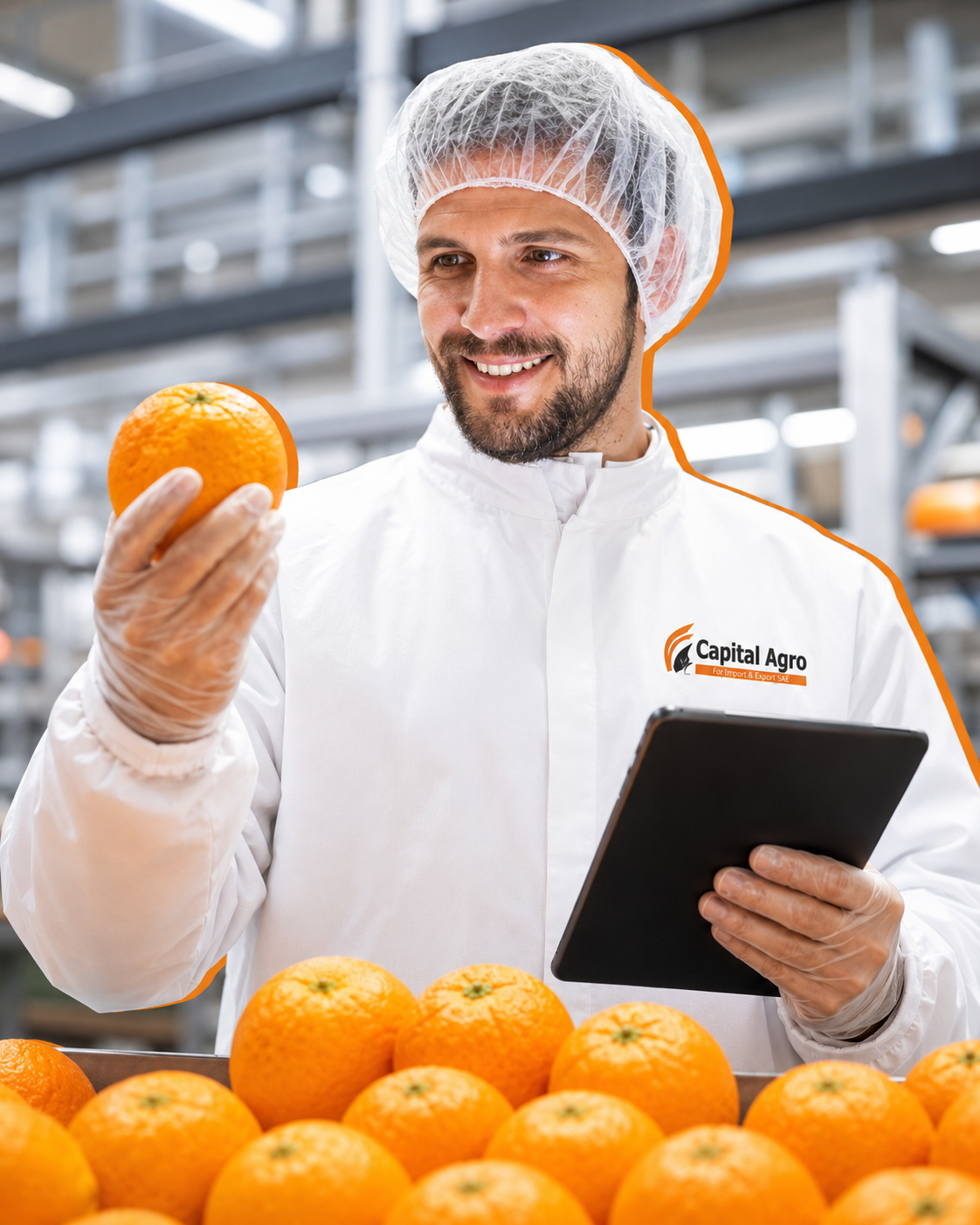 Capital Agro quality inspector holding an orange in the packing facility